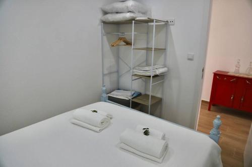 Santo António da TerrugemSítio DaTerra的一张白色的床,上面有两条毛巾