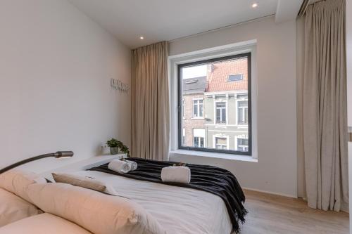 根特Margriet Apart-Suites的一间卧室设有一张床和一个大窗户