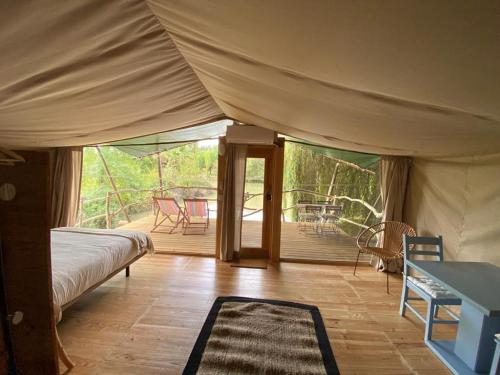 阿尔科巴萨Parque dos Monges的一间卧室,配有带桌子的甲板的帐篷
