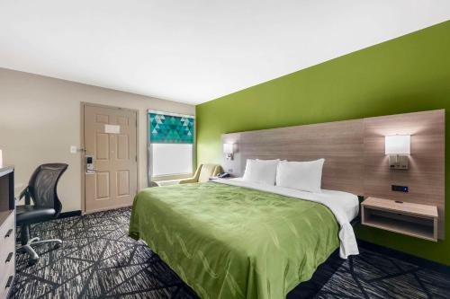 杰克逊杰克逊品质旅馆的酒店客房,设有床铺和绿色的墙壁