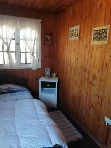 黑岛Habitación individual el amenecer de la Estancia的小木屋内的卧室,配有床和窗户