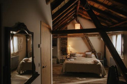 萨连特加列戈Casa Rural Valle de Tena的一间卧室配有一张大床和镜子