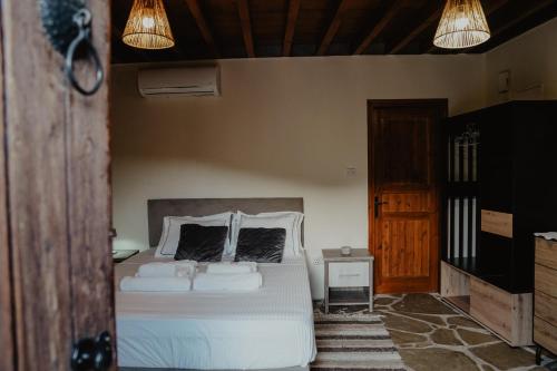 利马索尔The Stonehouse Suites的卧室配有白色的床和2个枕头