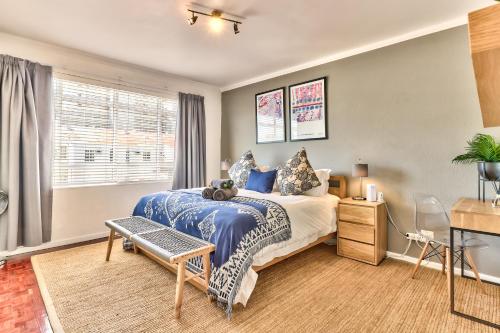 开普敦Trendy 1 bedroom flat in the heart of Green Point的一间卧室设有一张大床和一个窗户。