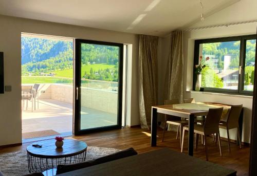 圣吉尔根Modern Living Sankt Gilgen的一间带桌子的客厅和一间享有美景的用餐室