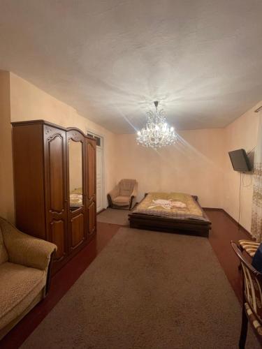 奥恰姆奇拉Мир的一间带一张床和吊灯的客厅
