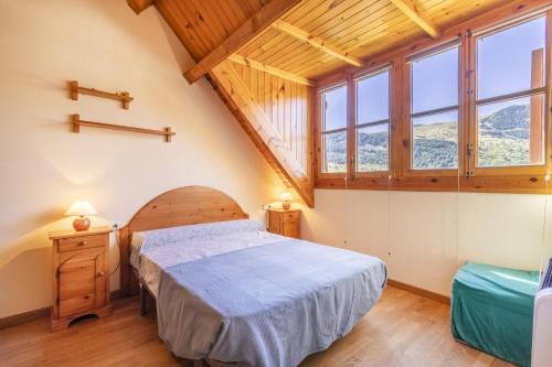 普拉德埃米塔La Cabanyeta de la Vall de Boí的一间设有床铺的卧室,位于带窗户的房间内