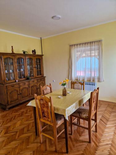 瓦列沃Prenoćište Mali Raj的一间带木桌和椅子的用餐室