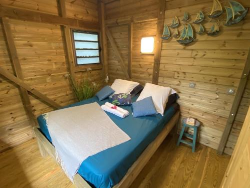 圣安尼Kaz ananas, spa privatif ,plage du Helleux的小木屋内一间卧室,配有一张床