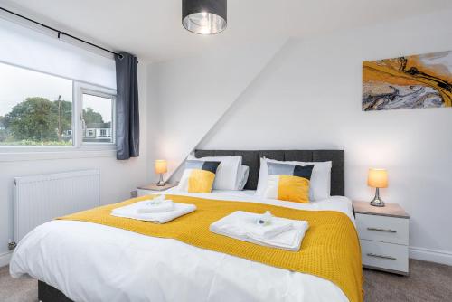 陶德维克Spacious Modern Home in Sheffield的一间卧室配有一张大床和两条毛巾