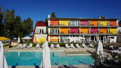 希欧福克Colors Holiday Hotel的一座设有游泳池、椅子和遮阳伞的酒店