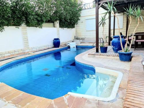 赫尔格达3 bedroom Villa W/ beach access的蓝色花瓶的院子内的游泳池