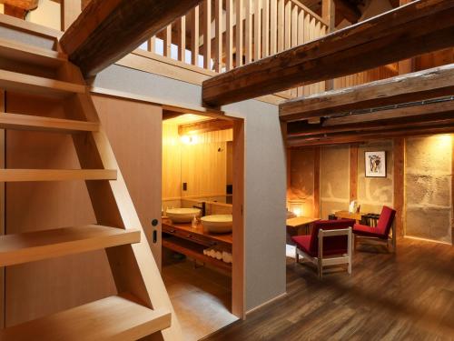 奈良NIPPONIA 田原本 マルト醤油的一间设有楼梯的房间和一间用餐室