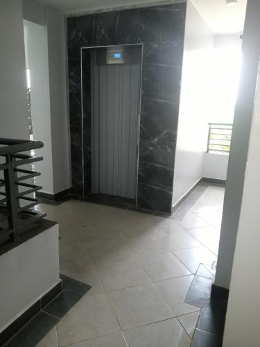 ThikaCarlyle comfort home的走廊上设有门,铺有瓷砖地板