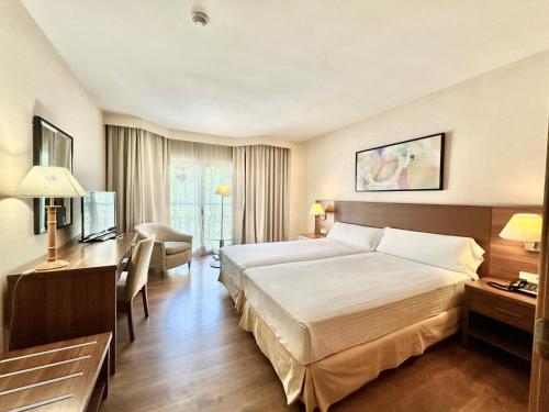 马德里罗萨雷斯公寓酒店的酒店客房设有一张大床和一张书桌。