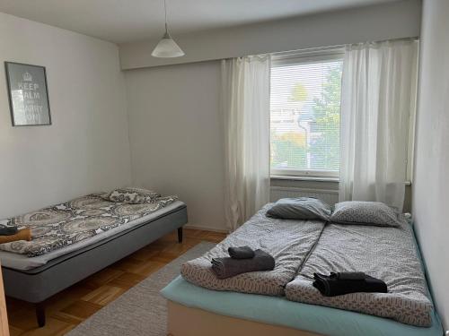 科科拉Apartment Puistokatu的一间卧室设有两张床和窗户。