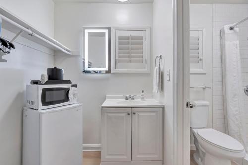 洛杉矶Santa Monica Hotel的白色的浴室设有卫生间和微波炉。