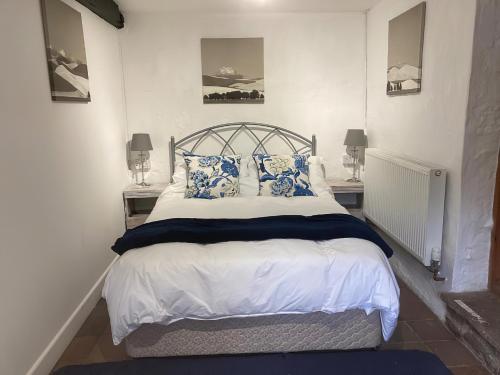 Great SalkeldThe Old Tearoom-uk32945的一间卧室配有一张带蓝色和白色枕头的床