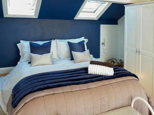 PenningtonWild Duck的一间卧室配有一张带蓝色墙壁的大床