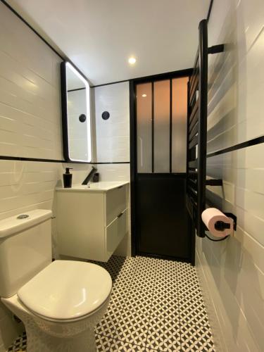 瓦兹河畔欧韦La Maison du Pere Pilon avec petit dejeuner的浴室配有白色卫生间和盥洗盆。