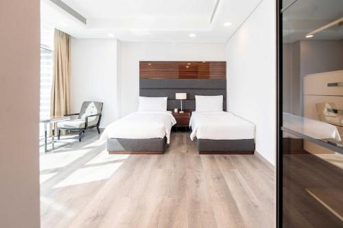 SeefS Plaza Suites Hotel的酒店客房配有两张床和一张书桌