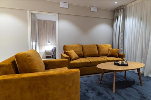 罗瓦涅米Royal Roi Apartments的客厅配有沙发和桌子