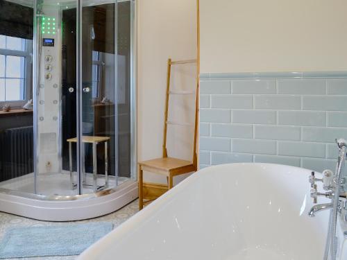 PlumblandHolmegarth的设有带浴缸和淋浴的浴室。