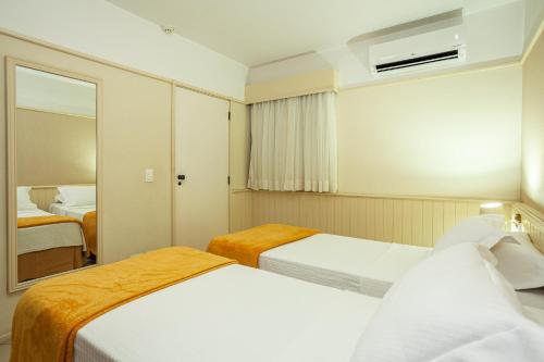 容迪亚伊圣查尔斯旅游旅馆的酒店客房,设有两张床和镜子