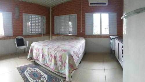 坎皮纳斯Quarto aconchegante Barão Geraldo的一间卧室配有一张床,厨房配有窗户