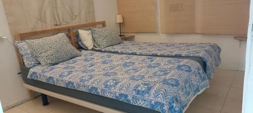 英格兰海滩Apartment 2-2 Playa del Ingles的一间卧室配有一张带蓝色棉被和枕头的床