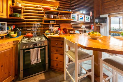 克尼斯纳艾德米里克伍德度假酒店的厨房配有炉灶和带桌子的桌子。