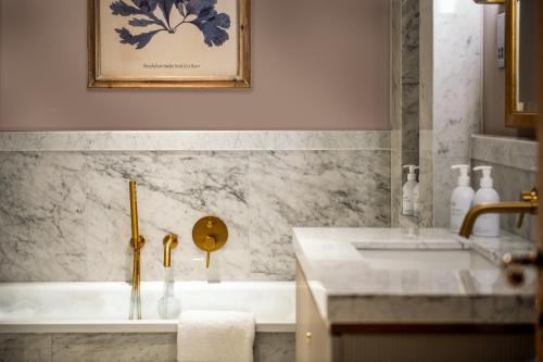温德米尔兰代尔切斯酒店的浴室配有盥洗盆和浴缸。