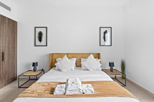 迪拜StoneTree - Elegant 1 BR in Madinat Jumeirah Living Rahaal 2的一间卧室配有一张床,上面有两条毛巾