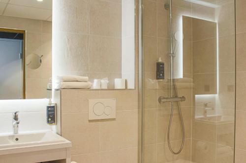 梅里尼亚克布里特酒店波尔多机场勒索雷泰尔店的带淋浴和盥洗盆的浴室