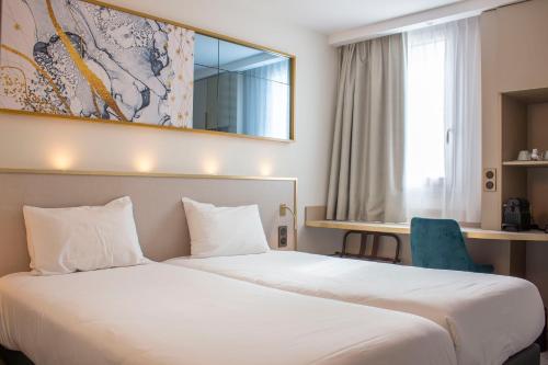 梅里尼亚克布里特酒店波尔多机场勒索雷泰尔店的酒店客房带一张大床和一把椅子