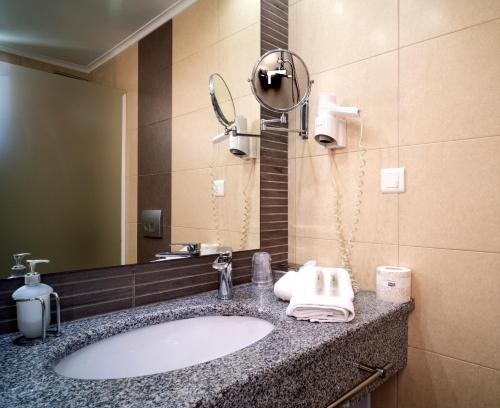 奈德里Armeno beach hotel的一间带水槽和镜子的浴室