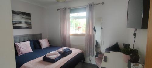 KinghornKINGHORN - Private room, ensuite & sunroom with Fab views的一间小卧室,配有一张带窗户的床