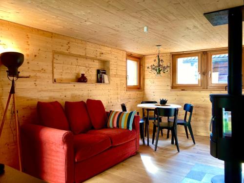 OscoLA CÀ NOVA. South Switzerland cozy gate away.的客厅配有红色的沙发和桌子