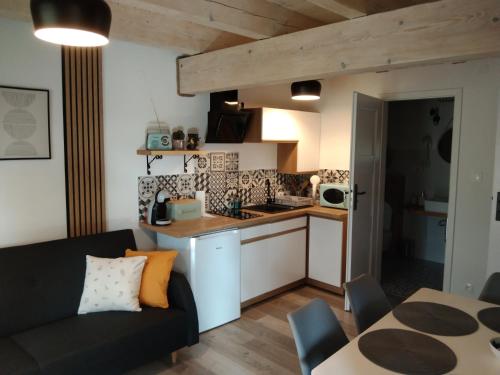下乌斯奇基Apartamenty Równia 2的厨房以及带沙发和桌子的客厅。