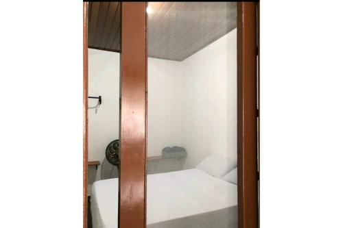 卡拉瓜塔图巴Cantinho do Sossego的滑动玻璃门,在房间内配有床