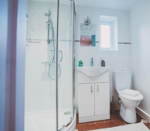 考文垂Equipped 5bed 2bath House in Coventry City FREE PARKING AMENITIES ROADLINKS WI-FI SMART TV的带淋浴和卫生间的白色浴室