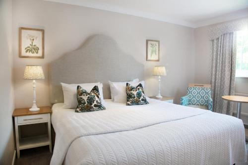 奥萨格Manor House Hotel & Spa, Alsager的卧室配有带枕头的大型白色床