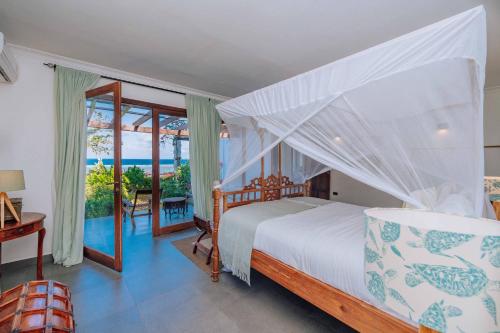 马特姆维Karabai Villa的一间卧室配有一张床,享有海景