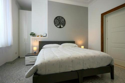 阿韦扎诺Al Castello Avezzano的卧室配有一张床,墙上挂着一个钟