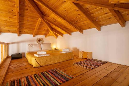 PemóniaPomogna house的铺有木地板的客房内设有一间卧室和一张床。