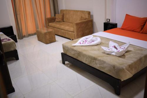 阿斯旺Kana Kato的一间卧室配有一张带椅子和椅子的床