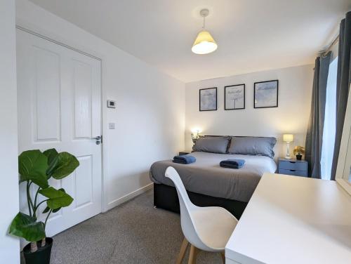 利物浦Guest Rooms Near City Centre & Anfield Free Parki的一间卧室配有一张床和一张桌子及椅子