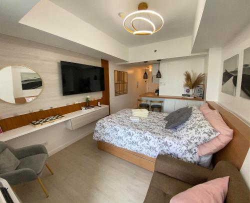 圣费尔南多LeisureStay Studio @ Azure North的一间卧室配有一张大床和镜子