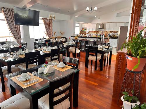 库斯科Hotel-Apartment INKASABIOS的餐厅内带桌椅的用餐室