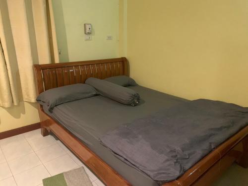 素攀武里รีสอร์ท สุพรรณ的一间卧室配有一张木架床